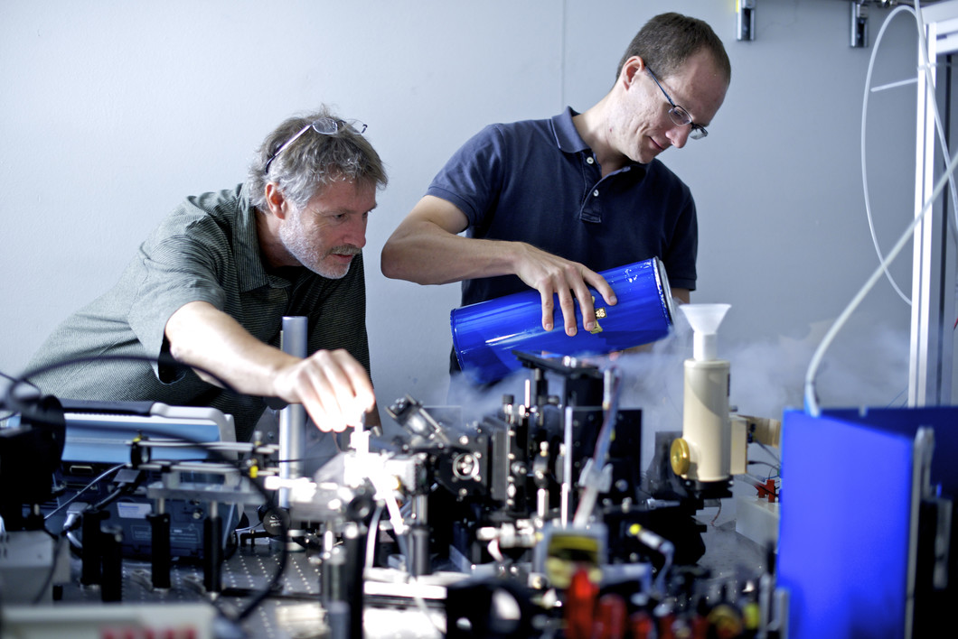 Hans Sigg und Peter Friedli bereiten an der Infrarotstrahllinie der SLS das Experiment zu Lasereigenschaften von Germanium vor. (Bild: Frank Reiser, Paul Scherrer Institut)