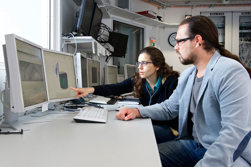 Les chercheurs du PSI Manuel Guizar-Sicairos et Ana Diaz discutent des images tomographiques d'une coquille d’œuf obtenus à l'aide des ordinateurs. Photo: Institut Paul Scherrer/Markus Fischer.