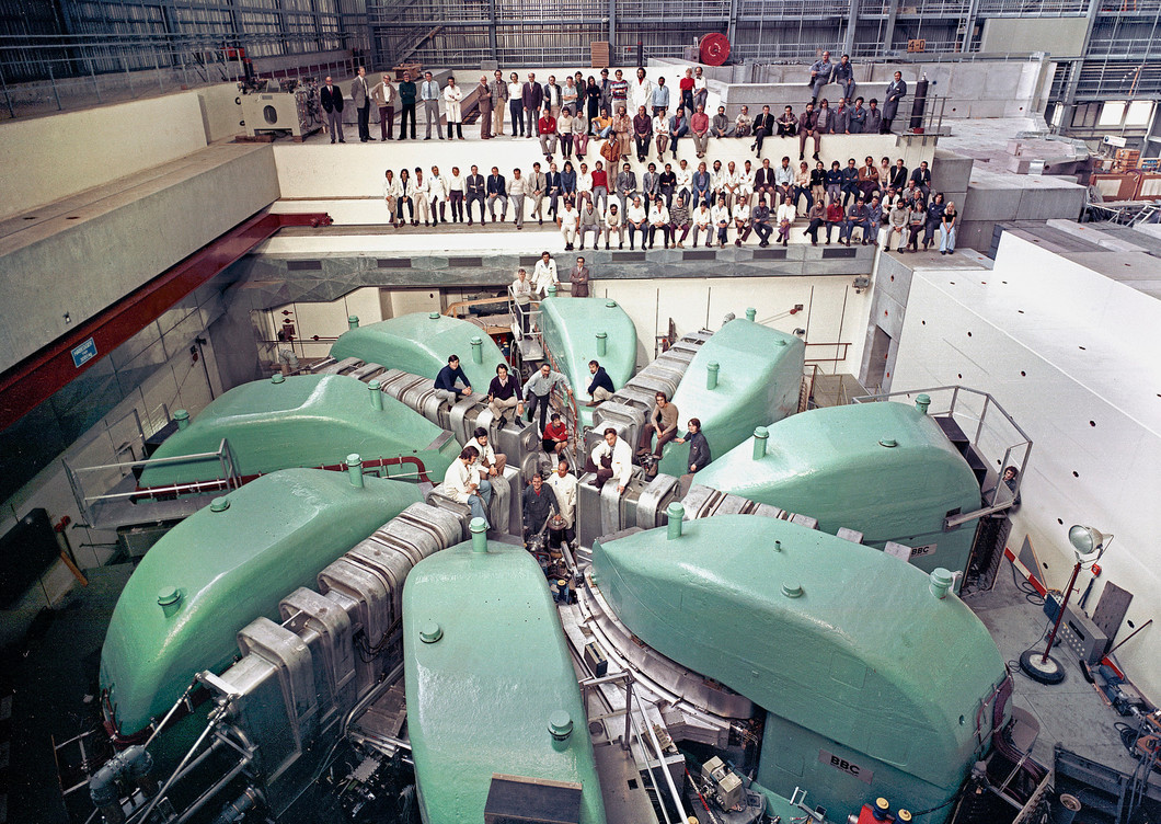 A group photo from 1973: Shortly before HIPA went into operation, people could actually sit on the big ring cyclotron, the last accelerator stage for the protons.