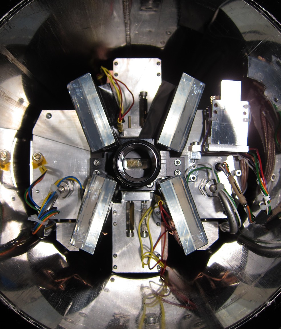 Picture of the gas target with the LAAPDs and scintillator detectors surrounding it. The target is sitting inside the bore hole of a 5T superconducting magnet.
