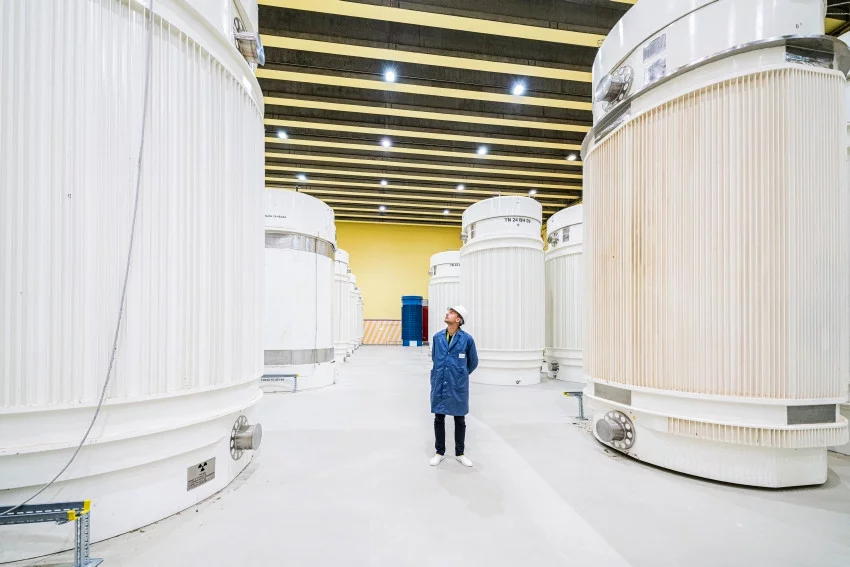 Postdoctoral researcher, Piotr Konarski, seems minute in comparison to these dry storage casks in ZWILAG, Würenlingen, Switzerland.