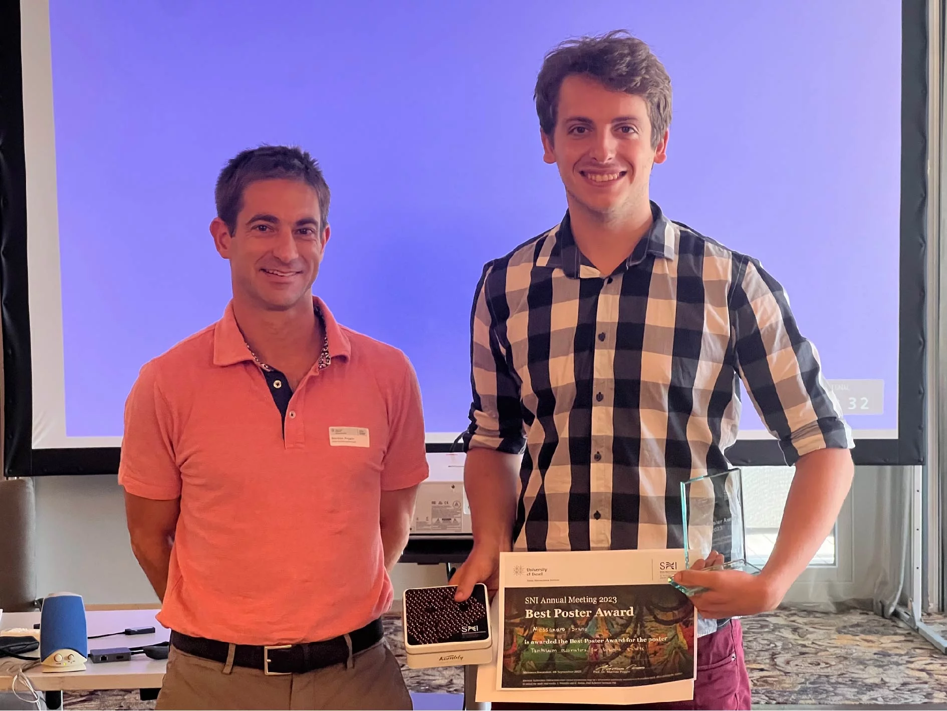 Prof. Martino Poggio presenting Alessandro with the award