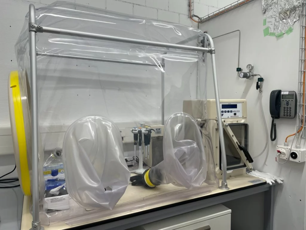 Large vinyl chamber with metal frame and some scientific equipment inside