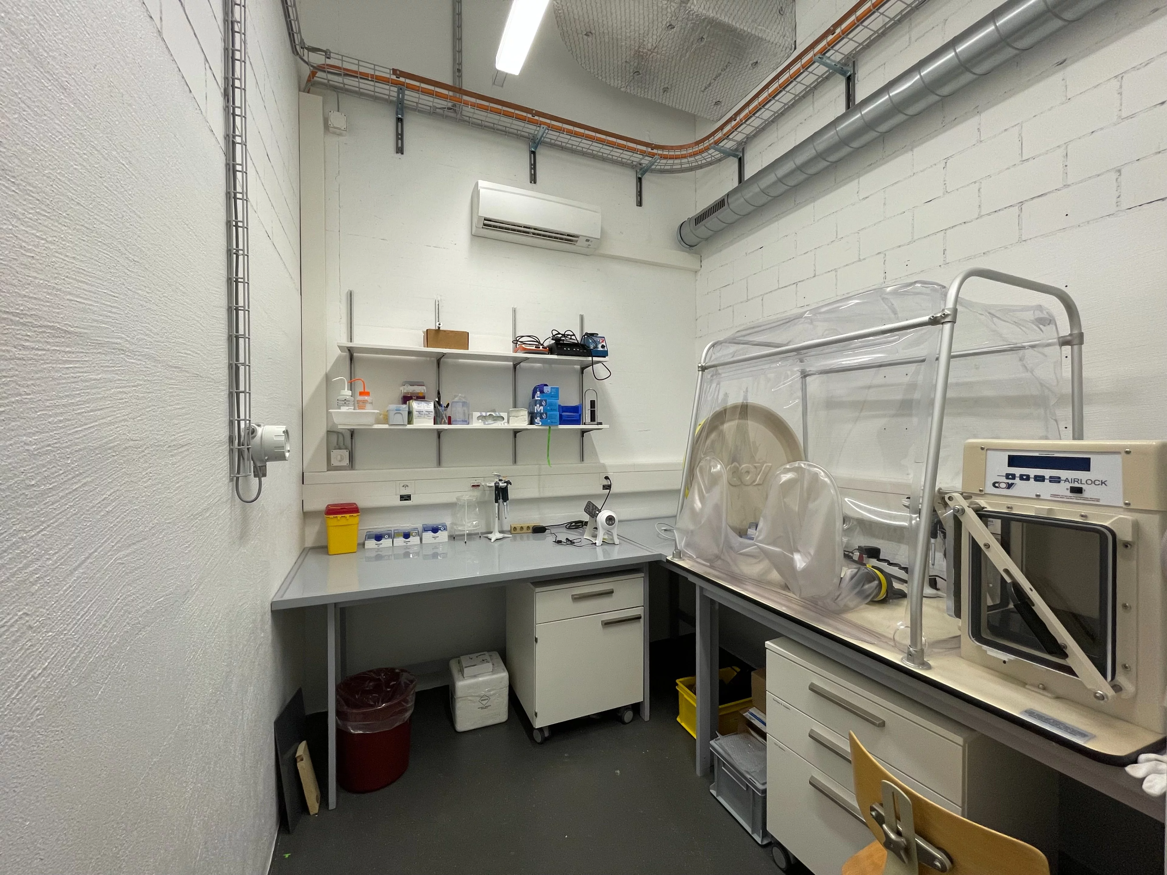 A laboratory with a plastic anaerobic glove box and some cabinets