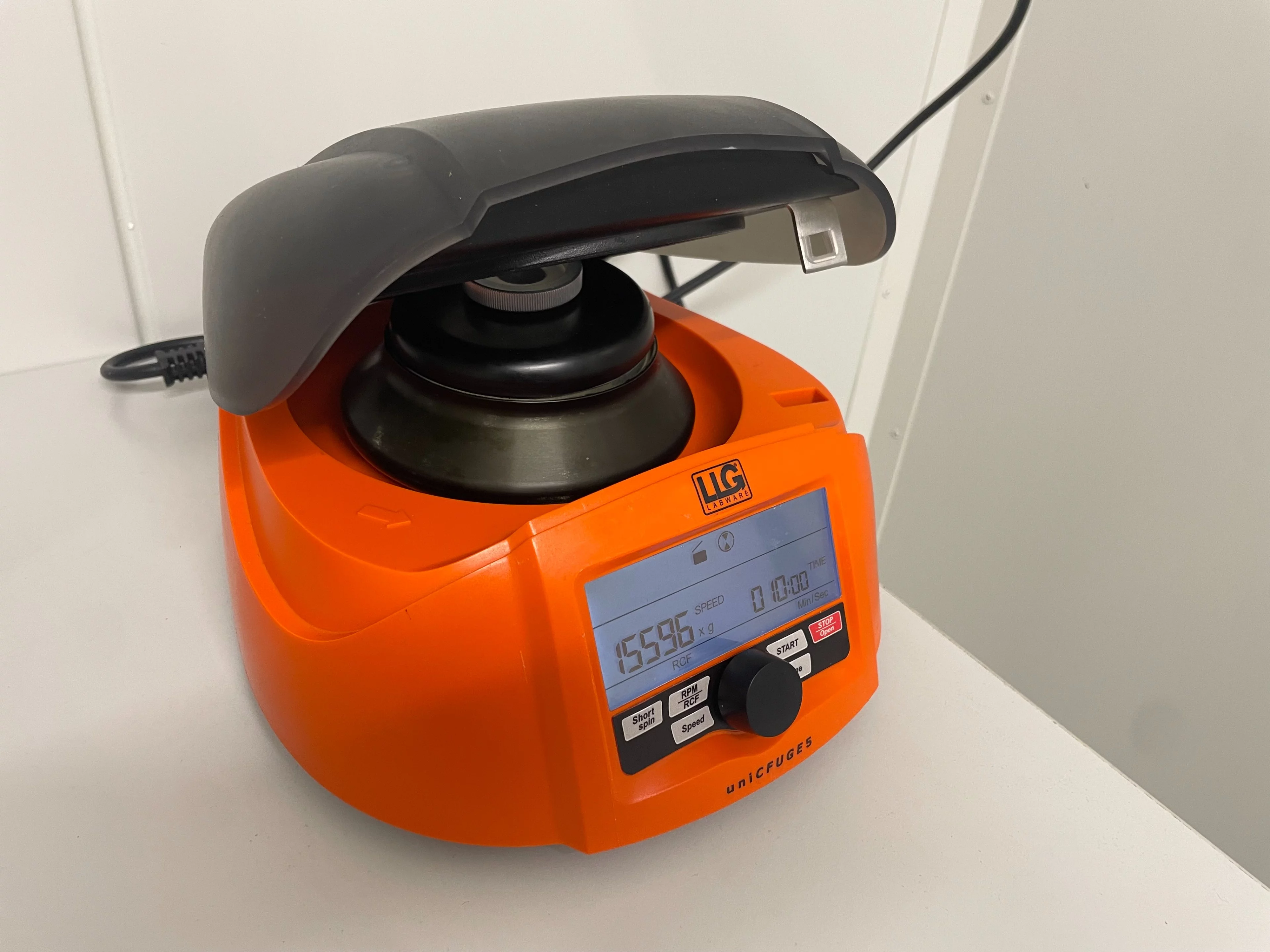 Orange and black minicentrifuge with digital screen