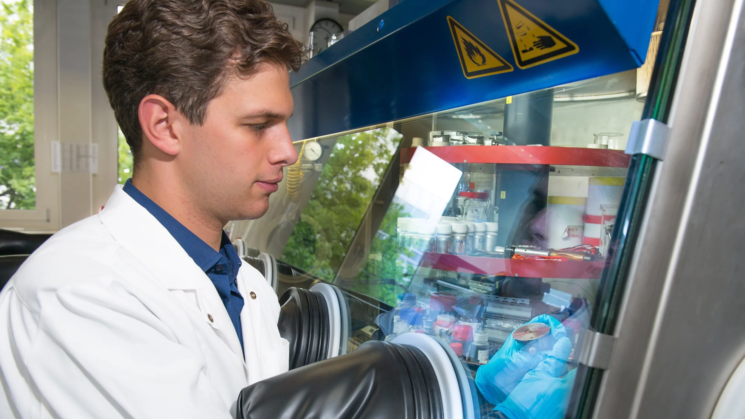 In his work, Patrick Lanz uses a glove box filled with argon to construct battery cells in a controlled atmosphere.