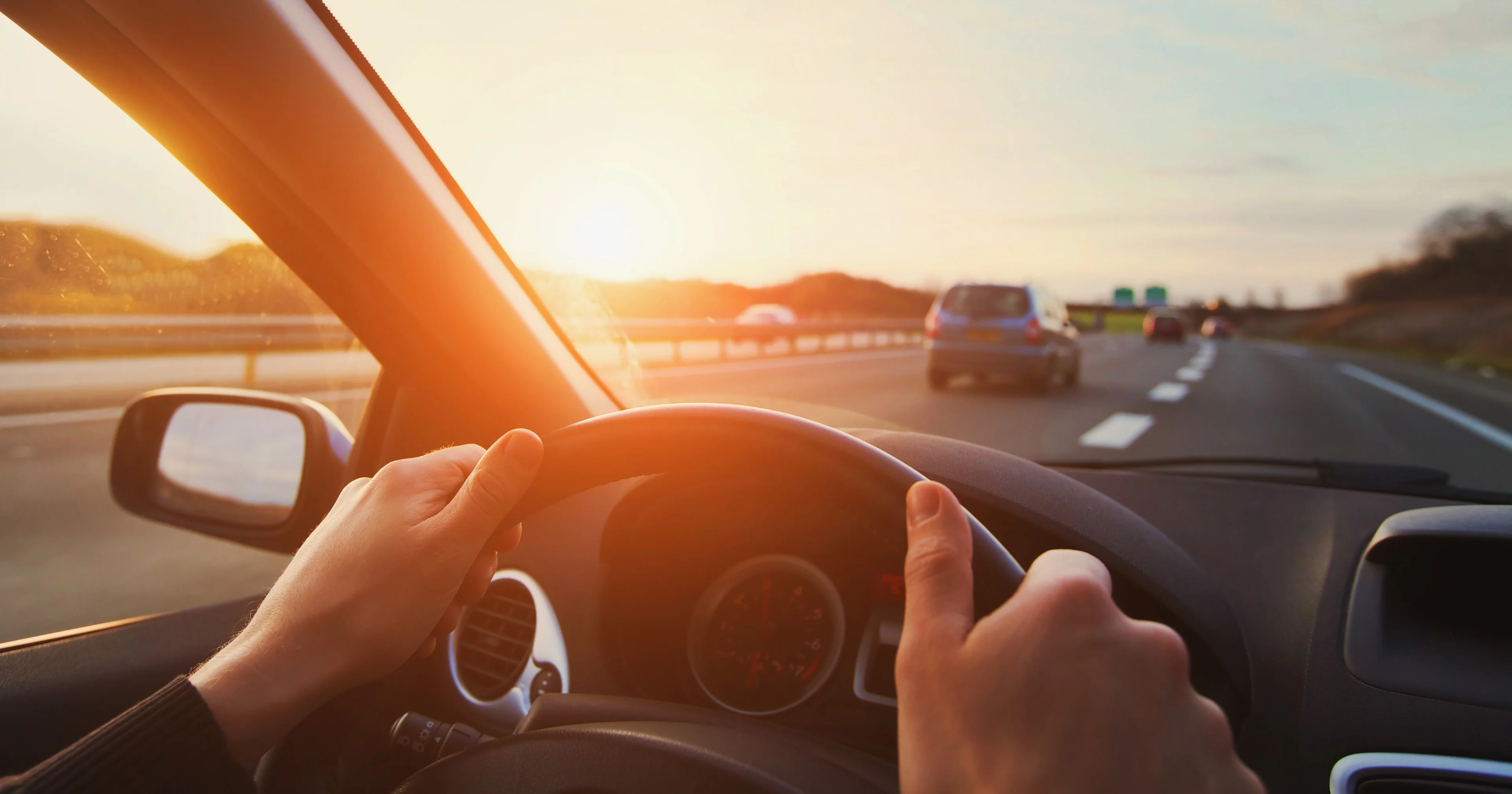 Photograph of someone driving a car on the highway