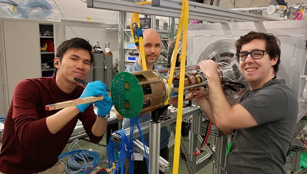 Figure 2Working in a team setting up the inner structure of the muEDM instrument at PSI.