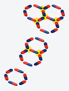 Magnetic nano-rods, arranged on the sides of a hexagon (bottom) or several hexagons (middle and top), form the ring systems studied by the scientists. Several linked rings serve as a model for a frustrated system: regardless of how the magnetisation of the central rod is oriented, energetically unfavourable conditions always arise, i.e. two north poles or two south poles will inevitably meet one another - marked in yellow.