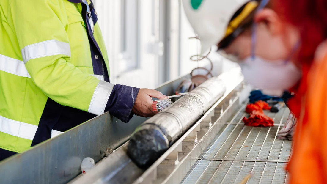 Drill cores are measured and samples are taken at the borehole site. 