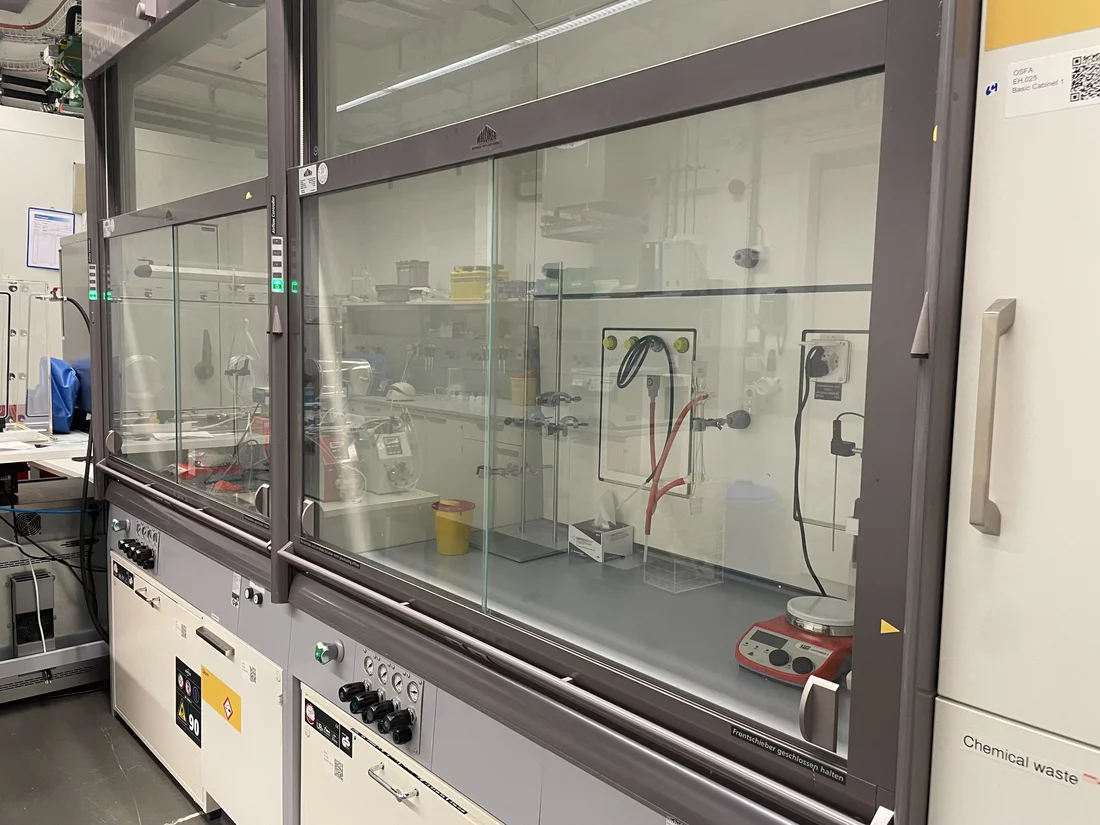 Two large fumehoods with various knobs and equipment inside