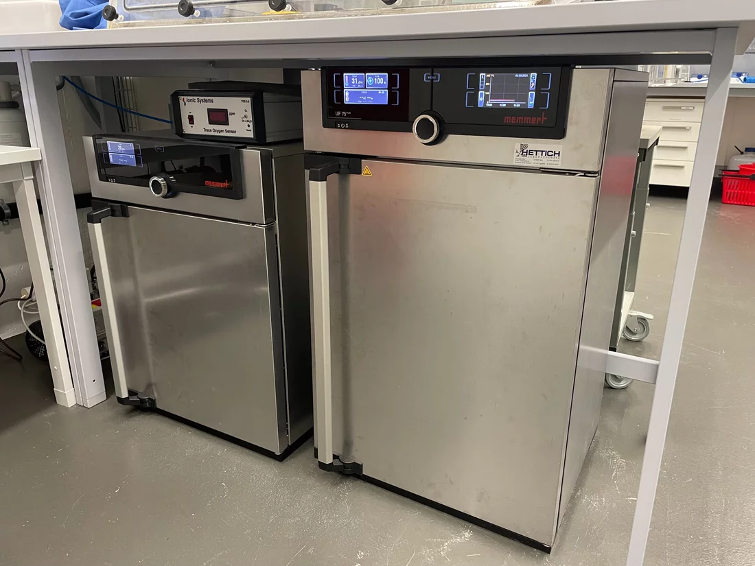 Two stainless steel incubators under a laboratory bench