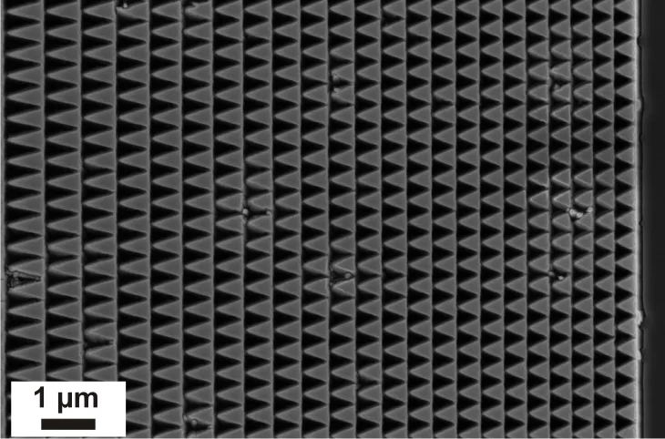 Scanning electron microscope images of diamond lens structures designed for blazed operation in tilted geometry.