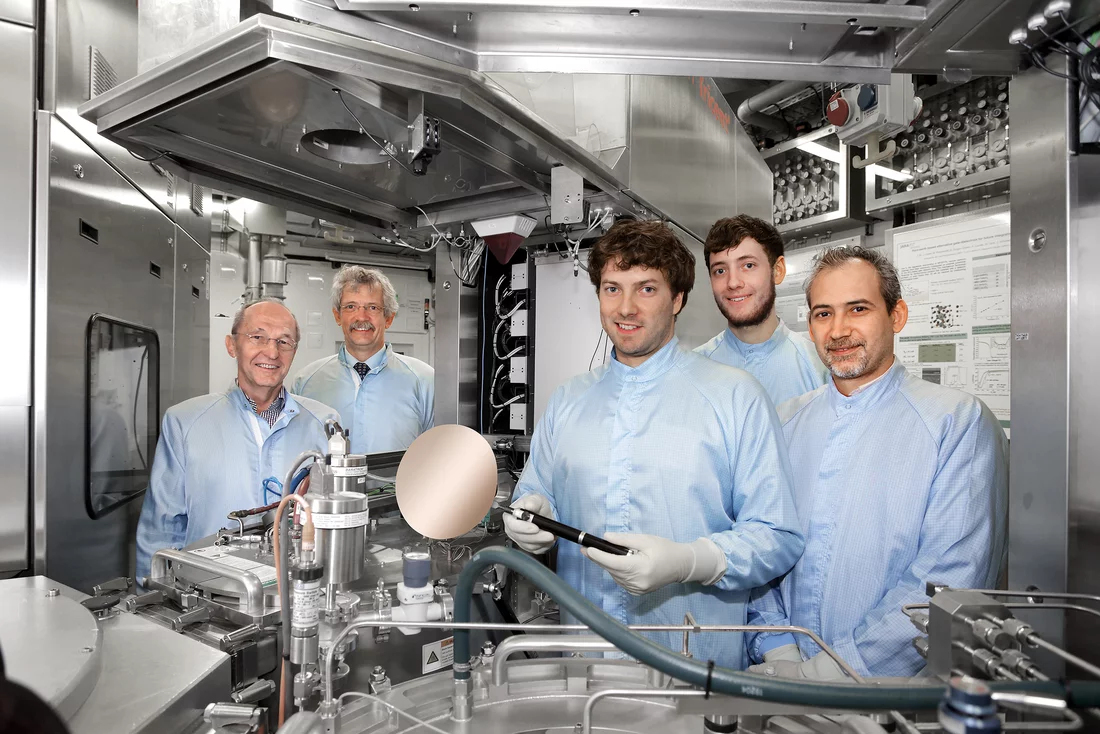 Scientists from the Peter Grünberg Institute (PGI-9) standing next to a CVD system which was used to prepare and develop parts of the new laser (from left: Prof. Siegfried Mantl, Prof. Detlev Grützmacher, Stephan Wirths, Nils von den Driesch and Dr. Dan Mihai Buca). (Copyright: Forschungszentrum Jülich)