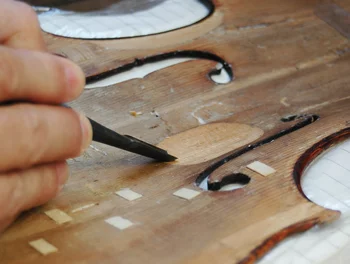 During violin repair work, small pieces of wood are always falling off.