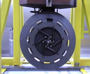 Target E (shown here in a test environment) of the meson production facility rotates at 60 revolutions per minute so that the proton beam always hits a new spot on the rim of the grey graphite wheel.