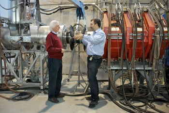 PSI researchers Peter-Raymond Kettle (left) and Stefan Ritt at the beamline, through which the muons reach the MEG experiment, where the extremely rare decay of the muon is supposed to be detected in a positron and a photon. (Photo: Paul Scherrer Institute/Markus Fischer)