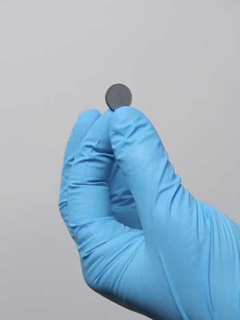 The matt grey pellet is a so-called layered copper-iron perovskite, a crystal. It can be placed on a fingertip. (Photo: Paul Scherrer Institute/Markus Fischer)