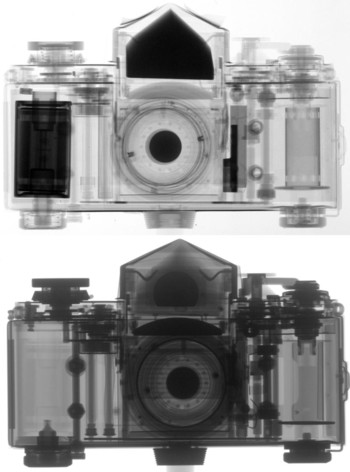 Figure 1: Radiograph of an analog camera: by neutrons (top) by X-rays (bottom). While X-rays are attenuated more effectively by heavier materials like metals, neutrons make it possible to image some light materials such as hydrogenous substances with high contrast: in the X-ray image, the metal parts of the photo apparatus are seen clearly, while the neutron radiograph shows details of the plastic parts.