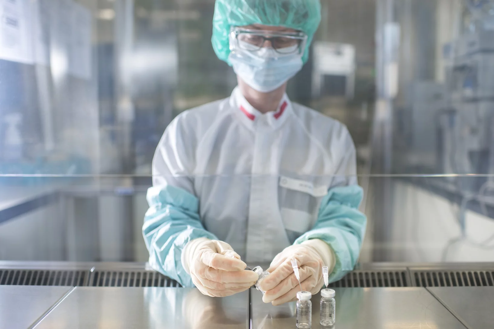 Neither dust nor germs are allowed in the clean room. Therefore pharmacist Susanne Geistlich works with sterile gloves and sleeves at a sterile work bench while she prepares non-radioactive precursors for the synthesis of a medicine. (Photo: Paul Scherrer Institute/Mahir Dzambegovic)